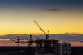 Construction tower crane, Industrial construction cranes on amazing sunset sky background Royalty Free Stock Photo