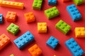 Construction toy. Colorful building bricks on red background, closeup Royalty Free Stock Photo