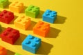 Construction toy. Colorful building bricks on yellow background, closeup Royalty Free Stock Photo