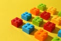Construction toy. Colorful building bricks on yellow background, closeup Royalty Free Stock Photo