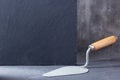 Construction trowel tool on cement background. Mason tools at concrete wall Royalty Free Stock Photo