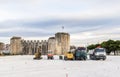 Construction trucks and tractors on a white field near the Kamerlengo fortress of the 15th century in Trogir, Croatia