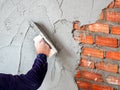 Construction under building with mason plastering concrete to brick wall Royalty Free Stock Photo