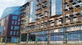 Construction of unfinished buildings, scaffolding, installation of windows. Royalty Free Stock Photo