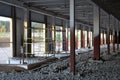 Construction of a warehouse complex, inside view. Columns are installed, crushed stone is laid on the floor.