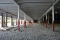 Construction of a warehouse complex, inside view. Columns are installed, crushed stone is laid on the floor