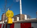Construction warning lantern on the background of a smoking chimney. Royalty Free Stock Photo