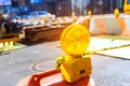 Construction warning lights are displayed on barricade in a road that is undergoing reconstruction