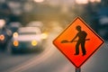 Construction warning sign on blur traffic road with colorful bokeh light abstract background Royalty Free Stock Photo