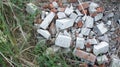 Construction waste. Heap of bricks grass Royalty Free Stock Photo