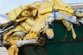Construction waste in a metal container. Disposal of hazardous industrial waste. Close-up