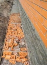 Construction waterproofing basement walls from outside with detail of a pavement