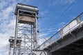Construction white gray metal two-tier draw bridge over the river, bottom view of the second tier with railway tracks Royalty Free Stock Photo
