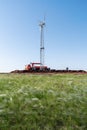 Construction of a wind power plant. Installation work using an aerial platform. Photo taken on a sunny summer day in the feather g Royalty Free Stock Photo