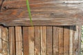 Construction wooden boards with old construction brown paint, green grass and sand after rain. Royalty Free Stock Photo