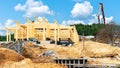 Construction of a wooden house from glued laminated timber. Double beam house constuction site. Concreting of retaining wall, Royalty Free Stock Photo