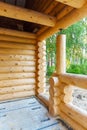 Construction of wooden house made of natural logs