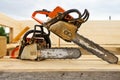 When construction a wooden house, two chainsaws a bit Royalty Free Stock Photo
