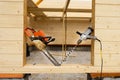 When construction a wooden house, two chainsaws a bit Royalty Free Stock Photo