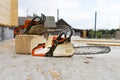 When construction a wooden house, two chainsaws a bit Royalty Free Stock Photo