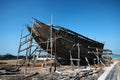 Construction of a wooden ship. Shipyard of traditional Dhow wooden boat on Iranian Qeshm Island. Tradition Lenj