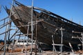 Construction of a wooden ship. Shipyard of traditional Dhow wooden boat on Iranian Qeshm Island. Tradition Lenj