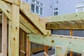 Construction of a wooden terrace floor above ground deck and patio of family home Royalty Free Stock Photo