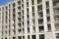 Construction work site of a multi-storey building showing frames of naked concrete walls with empty spaces. Contruction workes pro Royalty Free Stock Photo