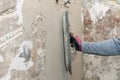 construction worker align the old wall with trowel and plaster