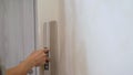 Construction worker align the old bathroom wall with trowel and plaster. A professional finisher painter levels the Royalty Free Stock Photo