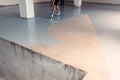 Worker apply grey epoxy resin in an industrial warehouse