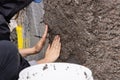 Construction worker applying cellulose insulation made from recycled paper to a wall Royalty Free Stock Photo