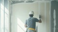 Construction Worker Applying Drywall Compound to a Wall Royalty Free Stock Photo