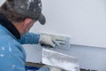 Worker plastering wall facade using hand trowel Royalty Free Stock Photo