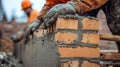 Construction Worker Applying Mortar to Brick Wall Royalty Free Stock Photo