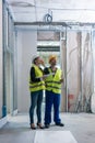 Construction worker and architect discussing work to be done at site Royalty Free Stock Photo