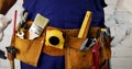 Construction worker arranges his tool belt