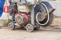 Construction worker with asphalt cutting machine