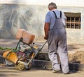 Construction worker with an asphalt sawing machinery