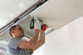 Construction worker assemble a suspended ceiling with drywall an Royalty Free Stock Photo