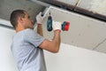 Construction worker assemble a suspended ceiling with drywall an Royalty Free Stock Photo