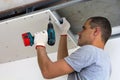 Construction worker assemble a suspended ceiling with drywall an Royalty Free Stock Photo