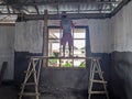 Bali, Indonesia. November 4, 2025. Construction workers are working on the windows of an unfinished building. Royalty Free Stock Photo
