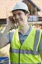 Construction Worker On Building Site Using Mobile Phone Royalty Free Stock Photo