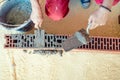 Construction worker building walls and fixing bricks with mortar and putty knife Royalty Free Stock Photo