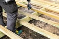 Construction worker building wooden frame for terrace deck Royalty Free Stock Photo