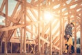 Construction Worker Builds Wooden Frame in Afternoon Sunlight at a Site Royalty Free Stock Photo