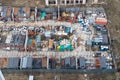 Construction worker camp and warehouse from aerial view. Construction trailers and materials on concrete site outdoors