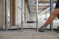 Construction worker installing electrical cable in a new building Royalty Free Stock Photo