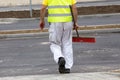 Construction worker carrying sweeping brush Royalty Free Stock Photo